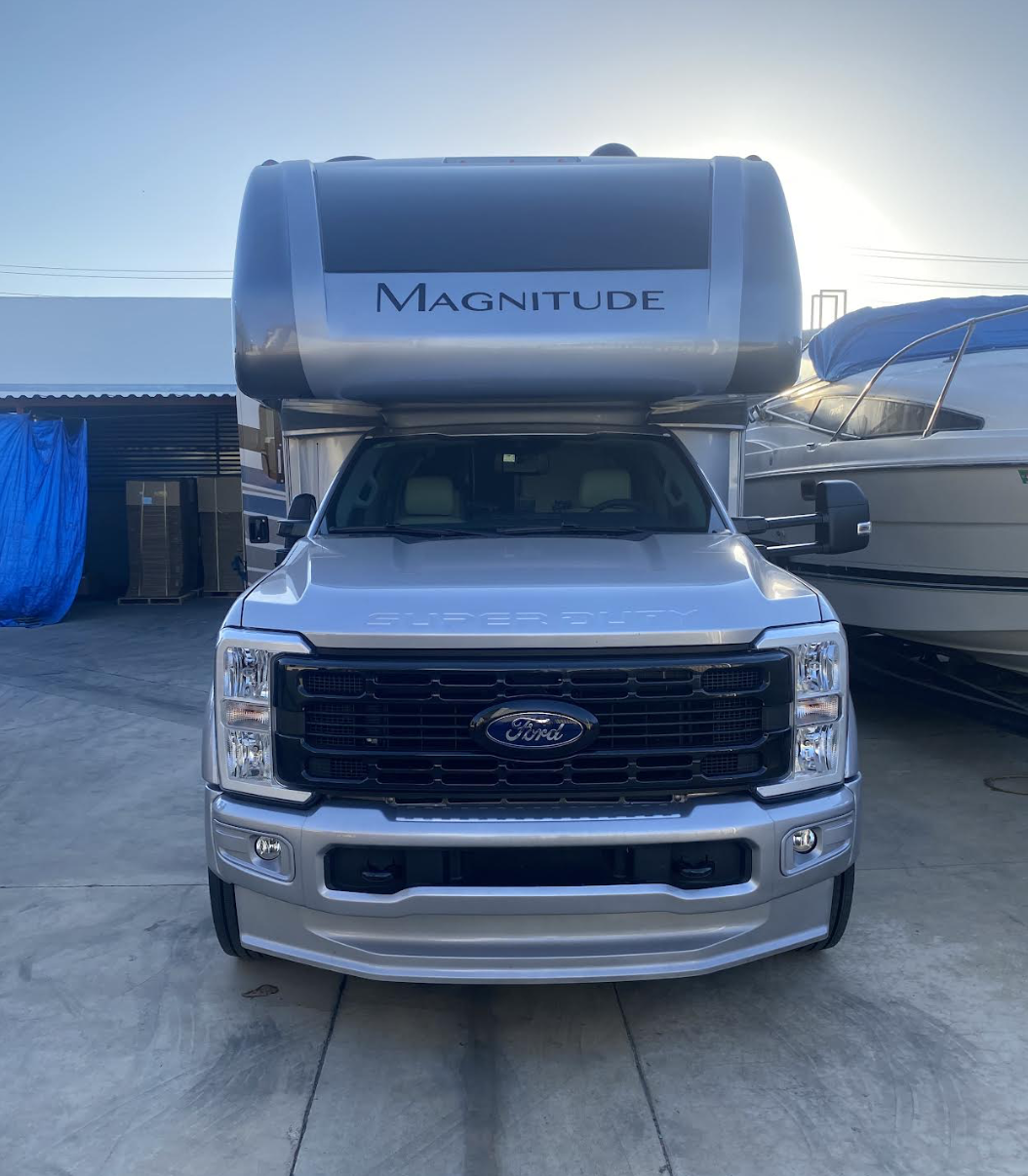Silver Ford Super Duty Magnitude motorhome at Upland Smog Center